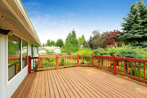 technician preparing wood deck for stain after cleaning